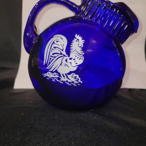 Beautiful deep cobalt blue tilted pitcher ice guard with rooster and ribbed neck