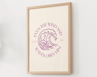 Può includere: Stampa artistica incorniciata con un design minimalista di un'onda in tonalità viola. Il testo "EVEN THE WIND AND WAVES OBEY HIM" circonda l'illustrazione dell'onda. La stampa è in una cornice di legno chiaro.