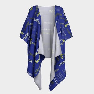 May include: A blue kimono-style robe with yellow text and a grid pattern. The robe features words like "creative," "vibrant," and "play." The inside of the robe is a light gray color.