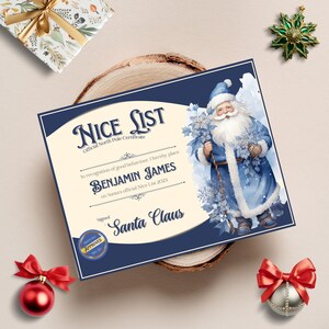 May include: A blue and white Christmas certificate with a cartoon image of Santa Claus holding a sprig of holly. The certificate reads "NICE LIST Official North Pole Certificate" and "In recognition of good behaviour, I hereby place BENJAMIN JAMES on Santa's official Nice List 2023 Signed Santa Claus".