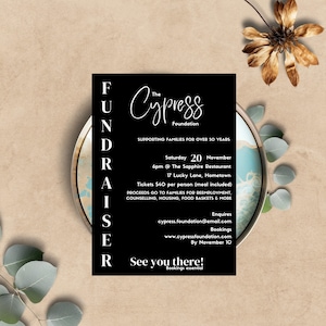 May include: Black and white flyer with the text "The Cypress Foundation" and "FUNDRAISER". The flyer advertises a fundraiser event on Saturday, November 20th at 6pm at The Sapphire Restaurant. The event will benefit families in need and includes a meal.