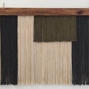 May include: A white ceramic mug with a black handle and the text "But First, Coffee" in a black, handwritten-style font. The mug is on a white surface.