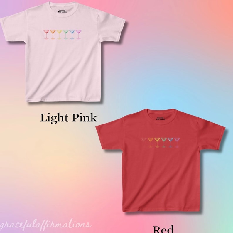Light pink and red version of the baby tee, which both have the same rainbow martini design