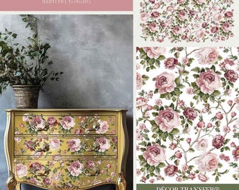 Puede incluir: Una cómoda dorada con un diseño floral con rosas rosas y hojas verdes. Los cajones están decorados con un diseño de transferencia llamado "Blushing Blooms Symphony" con el número de artículo 676315. La cómoda está sobre un fondo gris.