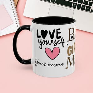 May include: White ceramic mug with a black interior and handle. The mug features the words "LOVE yourself" with a black heart and a pink heart, along with the words "Your name" and "Big Girl Magic".