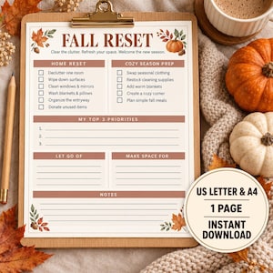May include: A Fall Reset checklist printed on white paper, secured to a wooden clipboard. The document features brown text, autumn leaf illustrations, and sections for home tasks, priorities, and notes. A wooden pencil rests beside the clipboard.