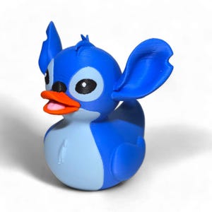 May include: Blue rubber duck with a Stitch character design. The duck has large ears, a blue body, and an orange beak.