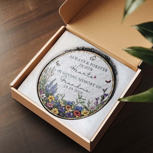 May include: An oval memorial plaque with floral and butterfly accents, presented in a gift box. The plaque reads "Always & Forever in our Hearts, In Loving Memory of Grandma 25.05.2025."