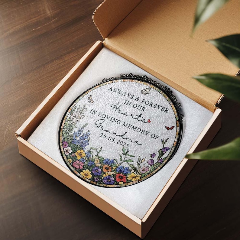 May include: An oval memorial plaque with floral and butterfly accents, presented in a gift box. The plaque reads "Always & Forever in our Hearts, In Loving Memory of Grandma 25.05.2025."