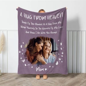 May include: Purple fleece blanket with a photo of two women and the text "A Hug From Heaven Think Of This Blanket As A Hug From Me. Wrap Yourself In The Warmth Of My Love And Know I Am With You Always. Mom"
