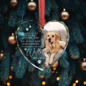 May include: A glass heart-shaped bauble with a photo of a golden retriever dog. The bauble has the text "IF LOVE ALONE COULD HAVE KEPT YOU HERE YOU WOULD HAVE LIVED FOREVER. Willow 2016-2024" printed on it.