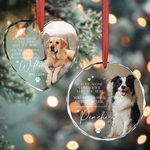 May include: Two glass baubles with paw prints and a dog photo on each. The heart-shaped bauble has a golden retriever with the text "IF LOVE ALONE COULD HAVE KEPT YOU HERE YOU WOULD HAVE LIVED FOREVER. * Willow 2016-2024". The round bauble has a black and white border collie with the text "IF LOVE ALONE COULD HAVE KEPT YOU HERE YOU WOULD HAVE LIVED FOREVER. * Peaches 2018-2024".