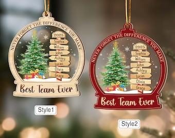May include: Two Christmas ornaments with a snow globe design. One is wooden, the other red. Each features a Christmas tree, gifts, and the text "Best Team Ever." Names and the year 2025 are also included.