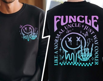 May include: Black sweatshirt with a graphic print of a smiley face with crossed eyes and a skeleton hand giving the rock and roll sign. The text "FUNCLE LIKE A NORMAL UNCLE JUST WAY COOLER" is printed on the back of the sweatshirt in purple and blue.
