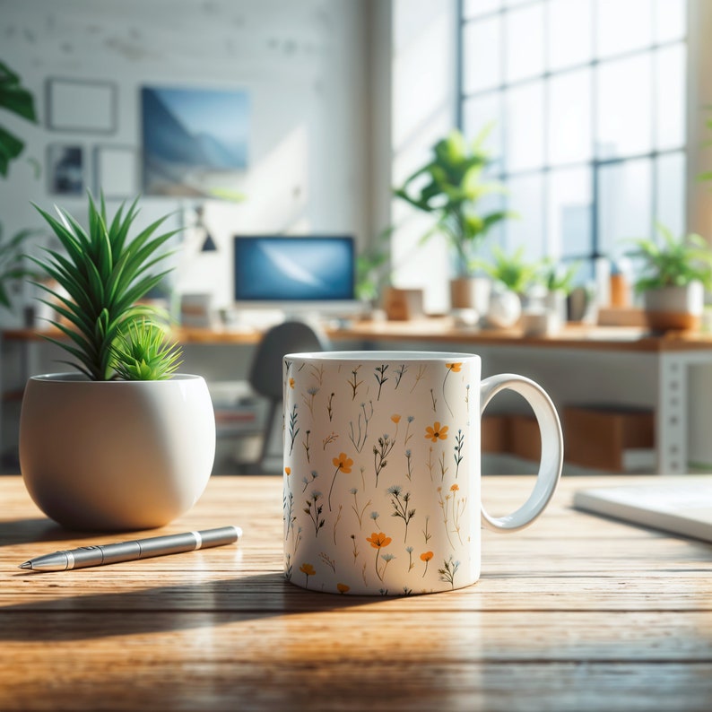 A mug with a dainty floral design with blue, yellow, and white flowers. The main color of the mug is white on the inside and outside.