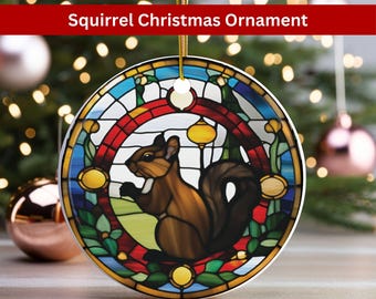 May include: A round ceramic Christmas ornament featuring a stained glass design of a squirrel in a forest setting. The ornament is decorated with shades of blue, green, red, and yellow.