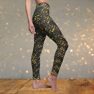 May include: Black leggings with a gold and black snake skin pattern.