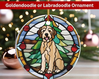 May include: A stained glass style Christmas ornament featuring a golden doodle dog sitting in front of a green Christmas tree. The ornament is round and has a white background with red and blue accents.