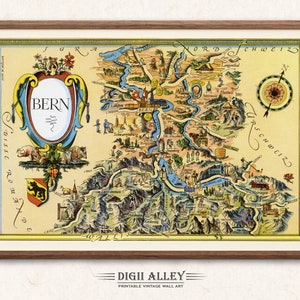 May include: A vintage illustrated map of Bern, Switzerland, with a colorful, detailed design. The map features the city of Bern, surrounding towns, and the Swiss Alps. The map is framed in a brown wooden frame.