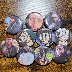 May include: Ten round button pins featuring different images of men. Some buttons feature cartoon-style illustrations, while others feature photographs. The buttons are all approximately 2 inches in diameter.
