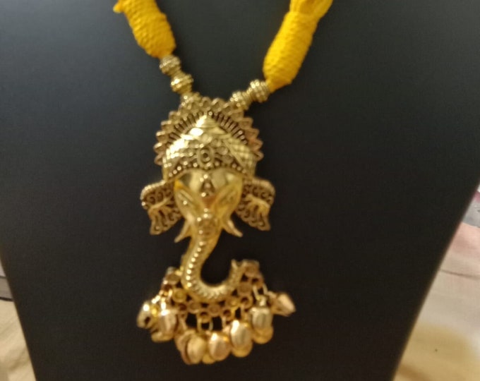 Oxidised golden ganesha traditional pendant and matching earrings.