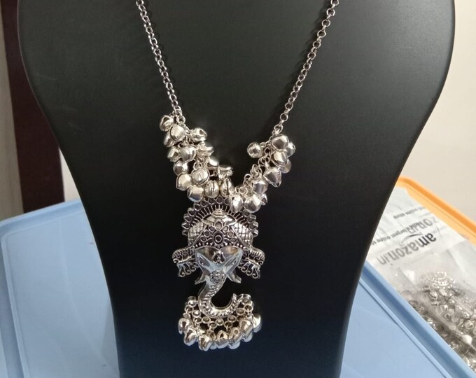 Oxidised silver chain with traditional pendant and matching earrings.