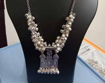 Oxidised silver chain with traditional pendant and matching earrings.