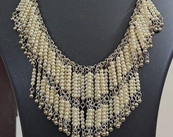 Exclusive layered off white seed beads necklace with matching hanging earrings.