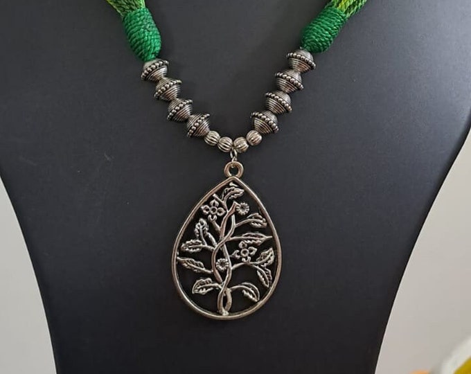 Green thread necklace with silver oxidised traditional pendant