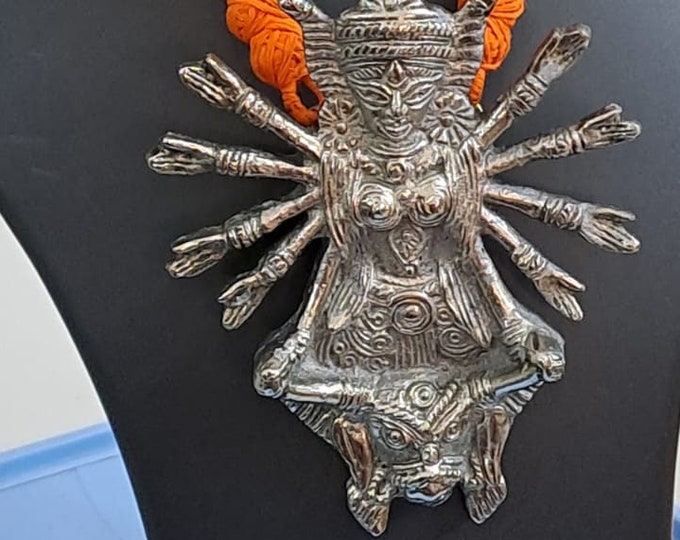 Orange thread necklace with oxidised silver durga pendant