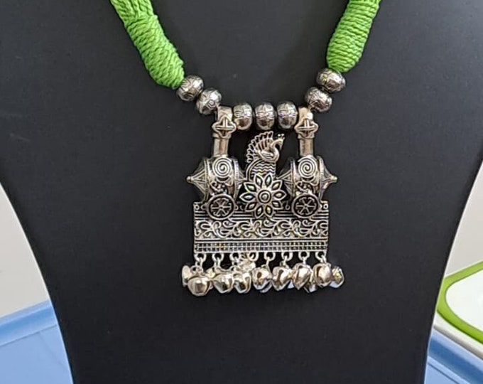 Light green thread necklace with silver oxidised traditional pendant