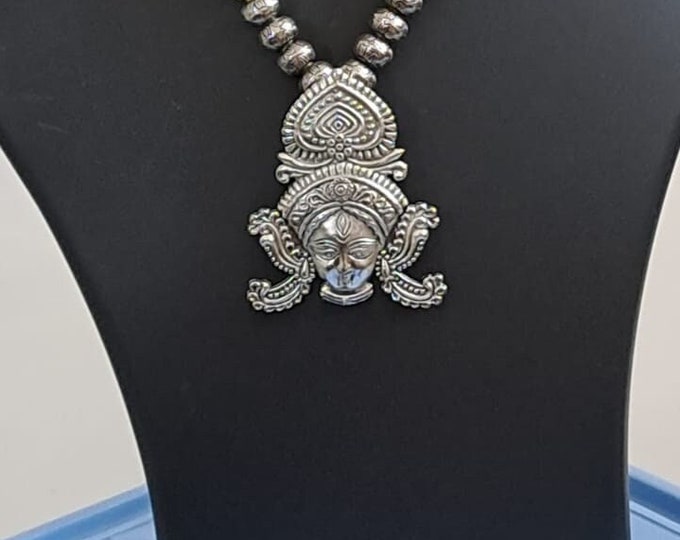 Off white thread necklace with oxidised silver durga pendant
