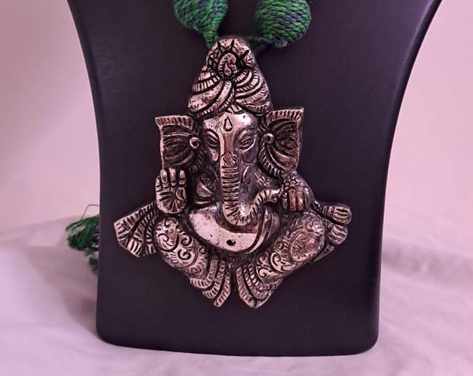 Green thread necklace with golden oxidised ganesha pendant