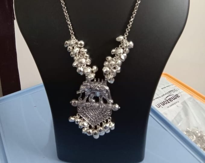 Oxidised silver chain with traditional pendant and matching earrings.