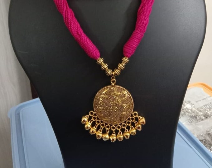 Red thread necklace with golden oxidised traditional pendant