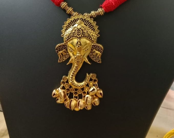 Oxidised golden ganesha traditional pendant and matching earrings.