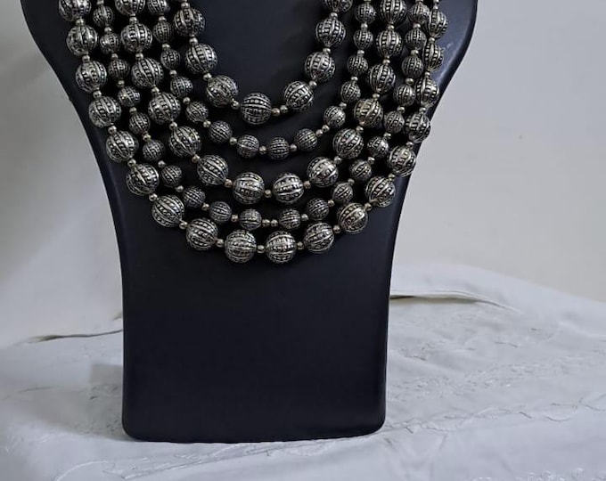 Multi-layered silver oxidised beads necklace .