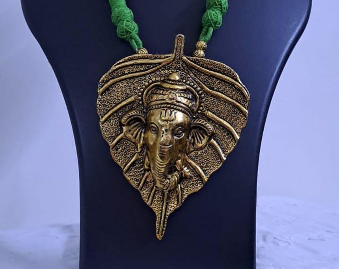 Green thread necklace with golden oxidised ganesha pendant
