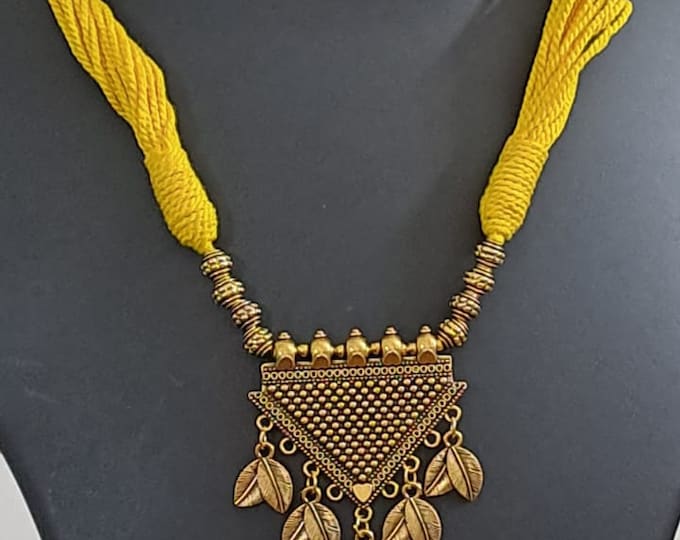Yellow thread necklace with silver oxidised traditional pendant