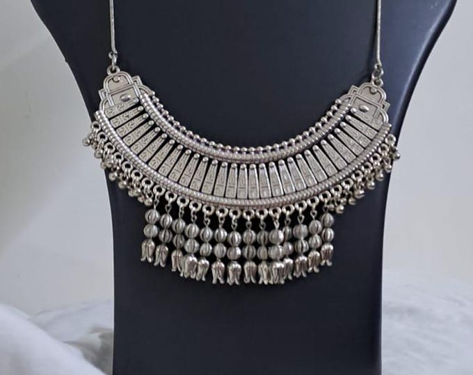 Exclusive necklace with silver oxidised big oval pendant with beads fringes and matching earrings.