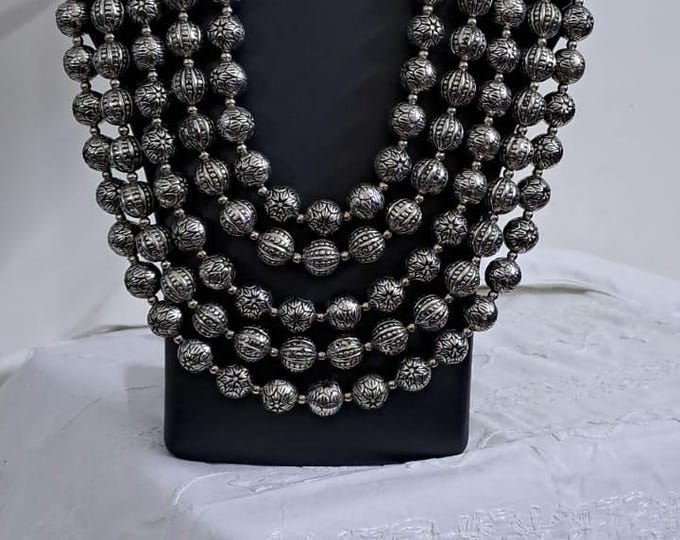 Multi-layered silver oxidised beads necklace .