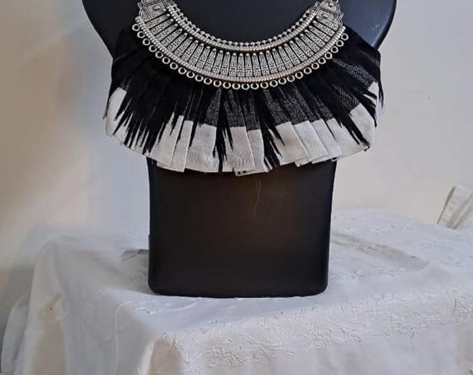 Exclusive necklace with silver oxidised big oval pendant with fabric fringes and matching earrings.