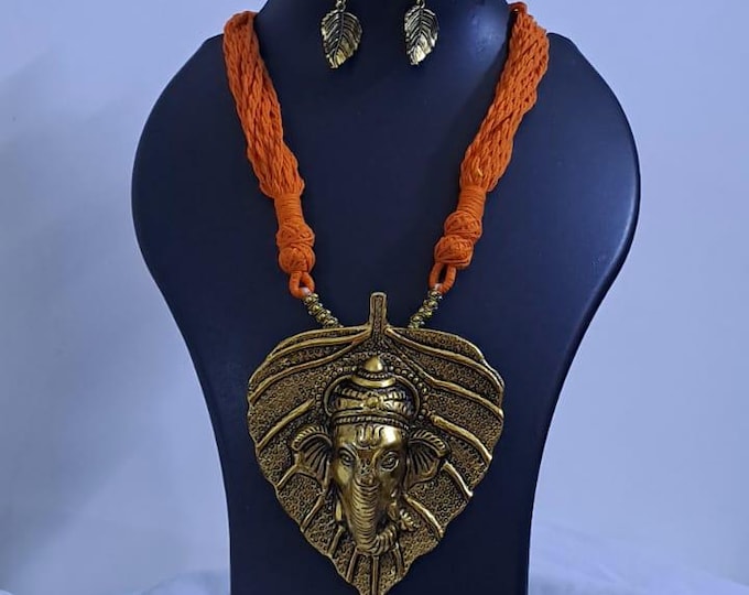 Orange thread necklace with golden oxidised ganesha pendant
