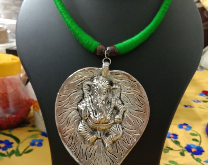 Green thread necklace with silver oxidised ganesha pendant