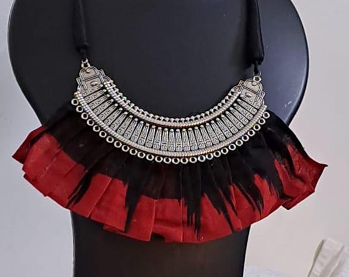Exclusive necklace with silver oxidised big oval pendant with fabric fringes and matching earrings.