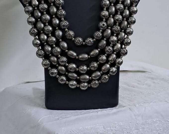 Multi-layered silver oxidised beads necklace .