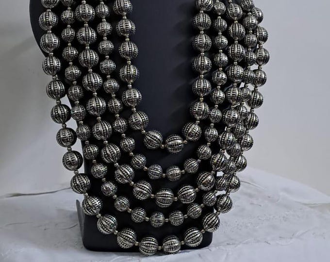 Multi-layered silver oxidised beads necklace .