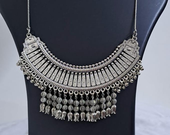 Exclusive necklace with silver oxidised big oval pendant with beads fringes and matching earrings.
