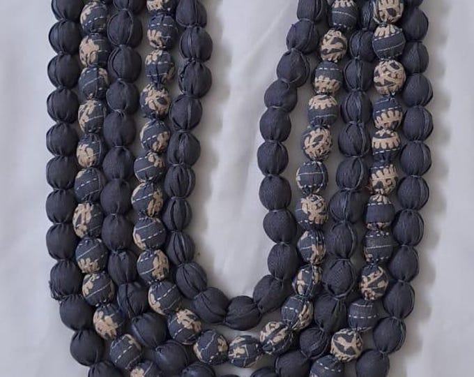 Exclusive multi-layered light grey fabric necklace