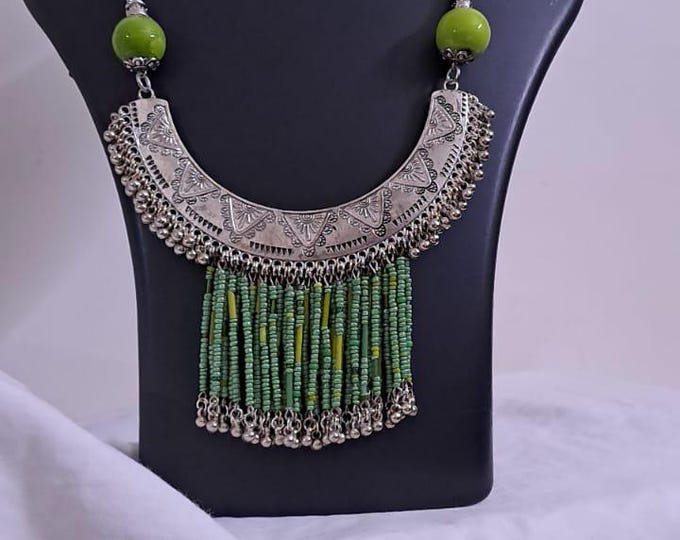 Exclusive necklace with silver oxidised big oval pendant with seed beads fringes and matching earrings.
